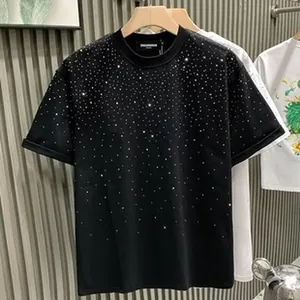 Detail of black crew neck T-shirt featuring sparkling rhinestone dot embellishments.