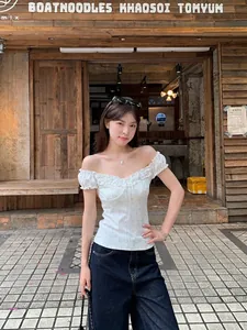 Trendy white off-the-shoulder floral crop top with ruffle trim and slim fit design