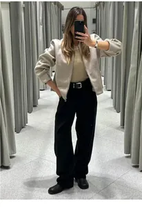 Stylish beige collarless zip-up jacket for women in a casual autumn outfit