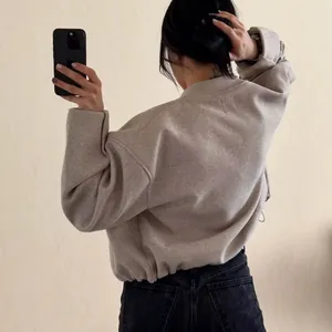 Casual soft beige crewneck jacket for women featuring an elastic hem and cozy fit