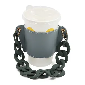 Elegant grey leather coffee cup sleeve featuring a thick matte green chain strap