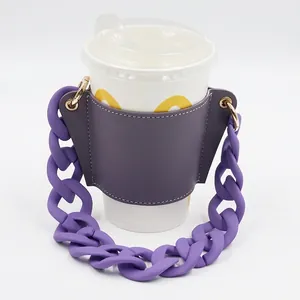 Detail of purple leather cup sleeve with chunky plastic chain handle on a white cup