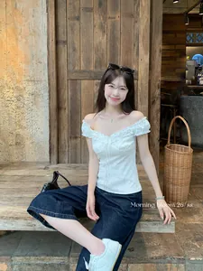 Detailed view of a white off-shoulder floral slim fit top with elegant ruffle trim details