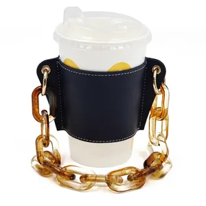 Detail view of black PU leather cup sleeve with detachable amber tortoise-shell chain.