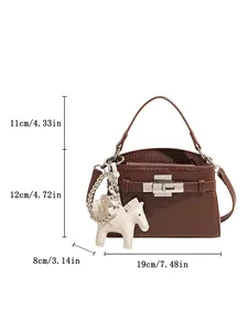 Detailed view of brown croc-pattern Kelly bag with horse charm and dimensions.
