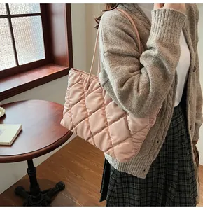 Stylish pink quilted puffer tote bag shown as a shoulder carry for daily winter use