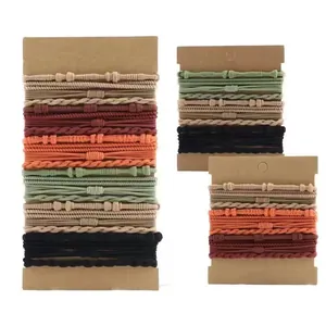 Detail view of bohemian handmade elastic hair ties in various earth tone colors and textures.