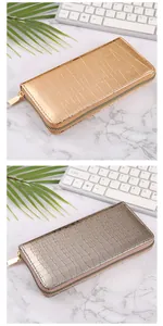Detailed view showing the crocodile texture on long women wallets in gold and silver