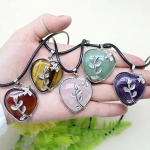 Five assorted heart-shaped natural stone pendants with silver rose detail on cords