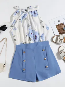 Women's summer two-piece outfit with floral halter top and blue buttoned shorts