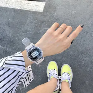 Transparent square sports LED digital watch for students worn on wrist in outdoor setting