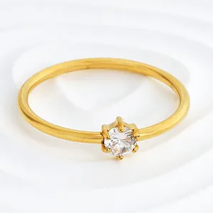 Close-up of golden stainless steel ring with six-prong round cubic zirconia