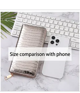 Shiny silver stone pattern long wallet shown next to a smartphone for size comparison