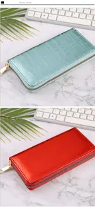Close-up detail of women's long wallets with glossy stone texture and gold zippers