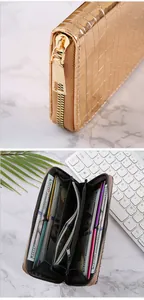 Detailed view of women's gold long wallet with stone pattern and interior card slots