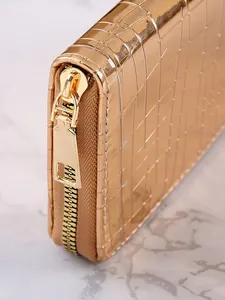 Detailed view of a stylish gold long wallet featuring a stone pattern texture and zip.