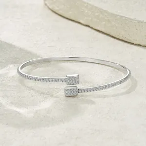 Detail view of a sterling silver open bangle set with sparkling moissanite stones