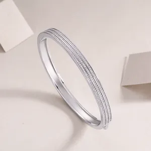 Elegant sterling silver open bangle featuring three rows of sparkling moissanite stones