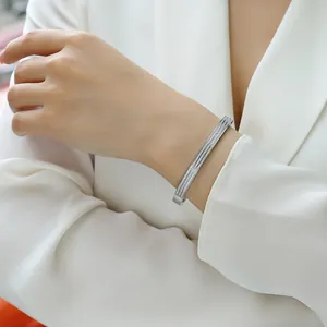 Close-up of elegant sterling silver open bangle with pavé-set moissanite stones