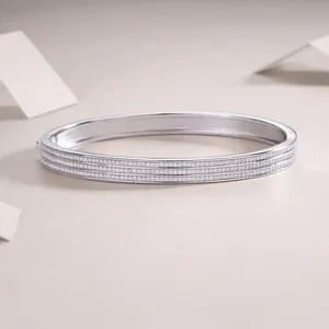 Close-up of elegant sterling silver bangle with triple-row moissanite stones