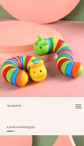 Detailed view of two colorful rainbow caterpillar fidget toys on a pastel pink background
