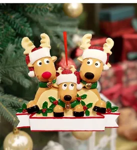 Detailed close-up of PVC Christmas reindeer family ornament with festive holly