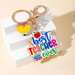 Close-up of 'Best Teacher Ever' keychain with heart pencil charm and colorful icons