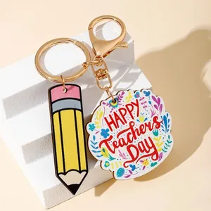 Close-up detail of Happy Teacher's Day keychain with pencil charm and floral design