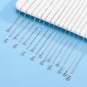 Detail view of various S925 and S999 sterling silver necklace chain styles on blue.