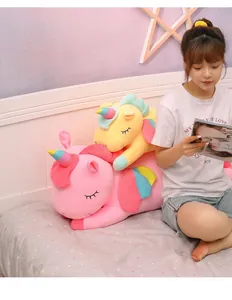 Close-up detail of soft pink and yellow unicorn plush toys in a cozy bedroom scene