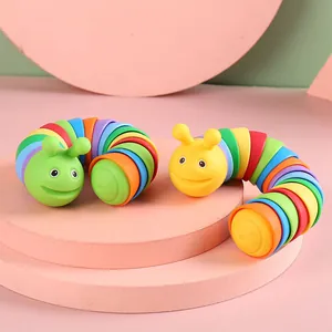Articulated rainbow fidget slug caterpillar sensory toy set on pink display platforms
