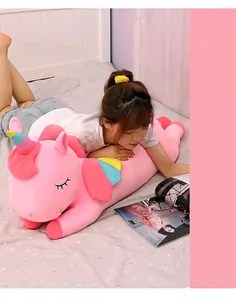 Extra soft pink unicorn plush long pillow shown being used as a comfortable body cushion