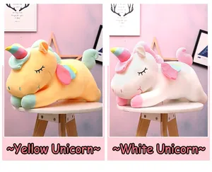 Close-up of cute yellow and white unicorn plush toys with rainbow wings