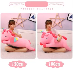 Comparison detail of pink plush unicorn toy in 120cm and 100cm sizes shown by a model