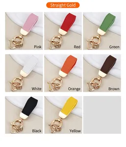 Detailed showcase of leather car keychains in eight vibrant colors with gold hardware.