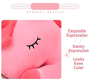 Close-up detail of a cute pink unicorn plush toy with embroidered sleeping eye