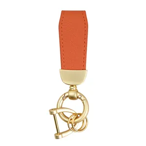 Orange goat-grain leather car keychain with high-quality gold-toned metal hardware