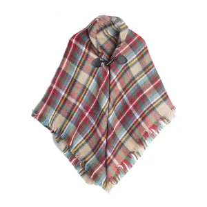 Cozy plaid poncho for children featuring a classic horn buckle and fringe detail.