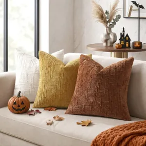 Close-up of textured grid pattern on decorative autumn-themed throw pillow covers