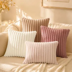 Close-up of soft ribbed plush throw pillows in various pastel colors on a cozy sofa.