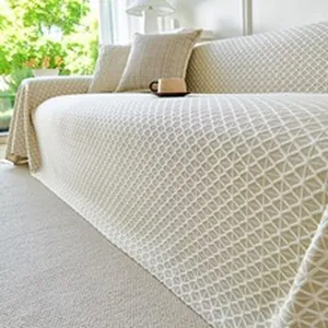 Detail view of the cooling ice silk sofa towel showing its elegant beige geometric pattern