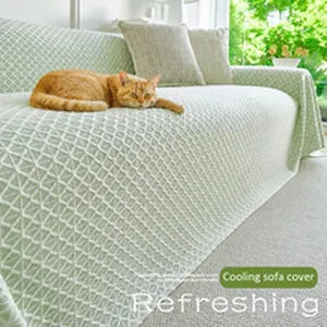 Refreshing light green checkered cooling sofa cover shown on a sofa with a sleeping cat