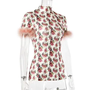 Close-up of floral high-collar slim t-shirt featuring pink faux feather sleeve trim