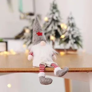Plush Christmas gnome doll with grey star hat sitting on a wooden table decoration