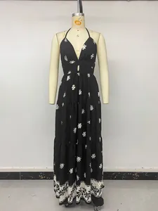Detailed view of a black vintage floral halter maxi dress with cutout waist on mannequin