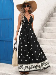 Detailed view of the vintage floral print on a summer holiday halter neck maxi dress.