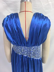 Back view detail of a blue satin evening gown featuring a sequined waist on mannequin