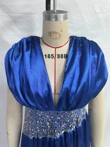 Detailed view of elegant blue satin evening dress with deep V-neck and sequined waist