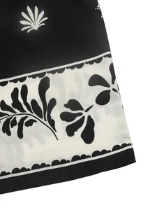 Close-up of retro floral print and fabric texture on black and white summer dress