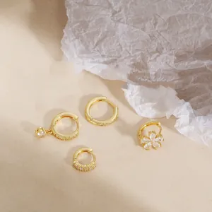 Elegant 18K gold-plated hoop earring set featuring a sparkling cubic zirconia flower pendant